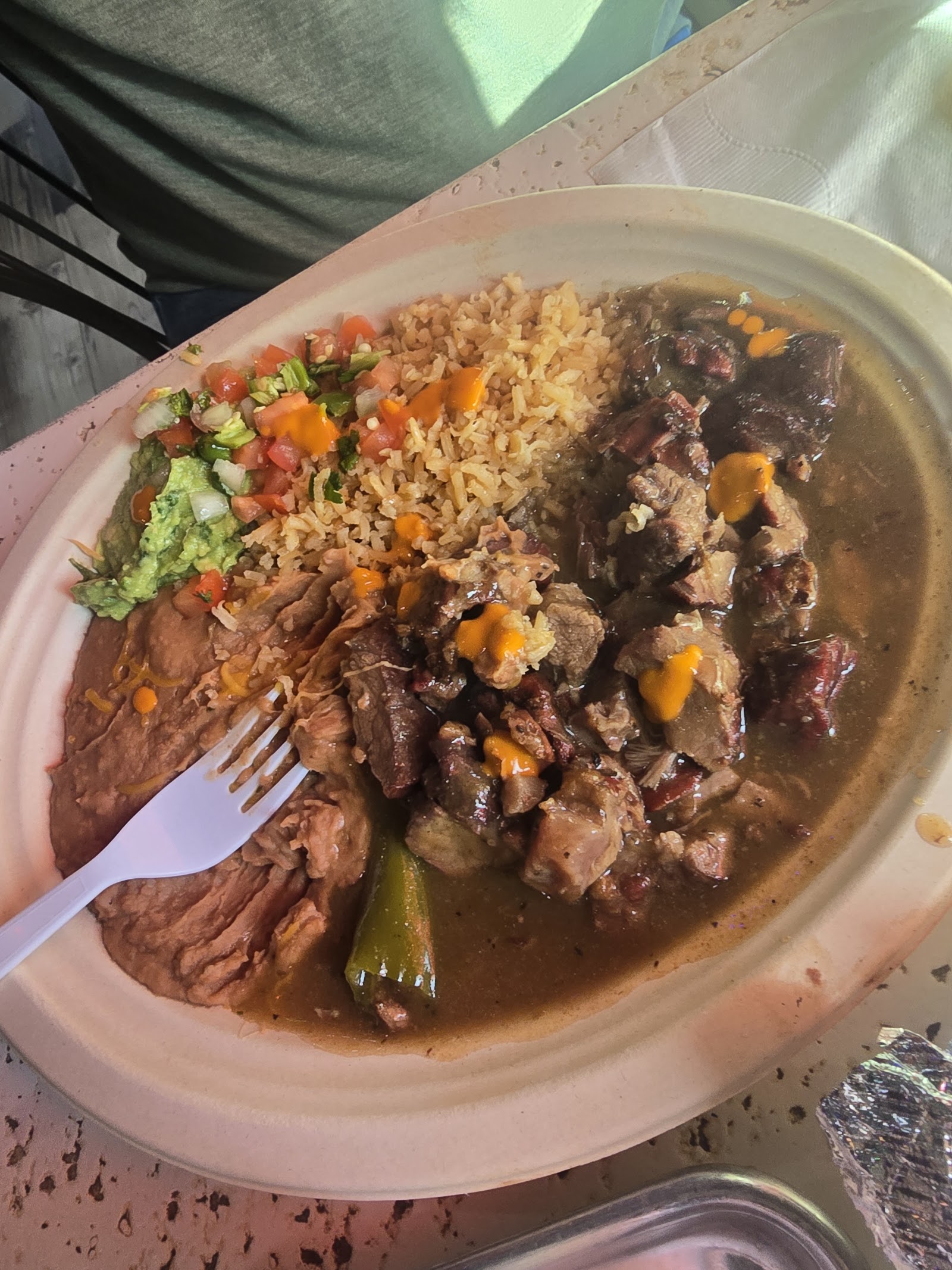 Fajita plate with rice, beans, and guacamole at Compadres Hill Country Cocina