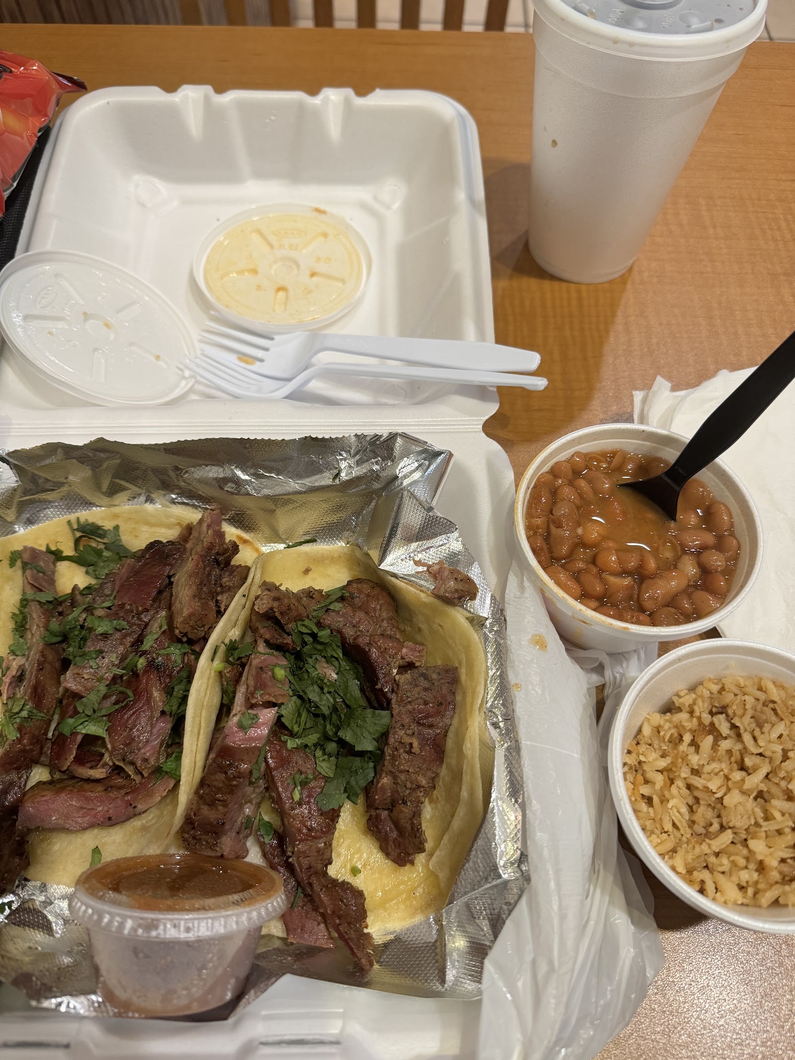 Grilled steak tacos with cilantro and rice and beans